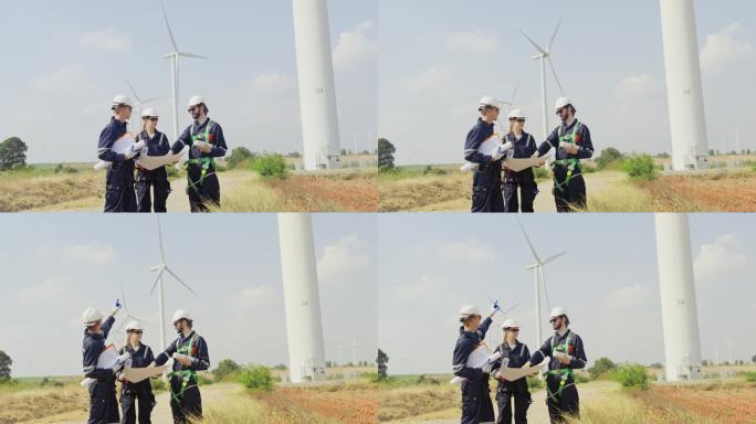 专业技术人员指着后面的风力发电机或风车，与电厂业务领域的同事讨论。