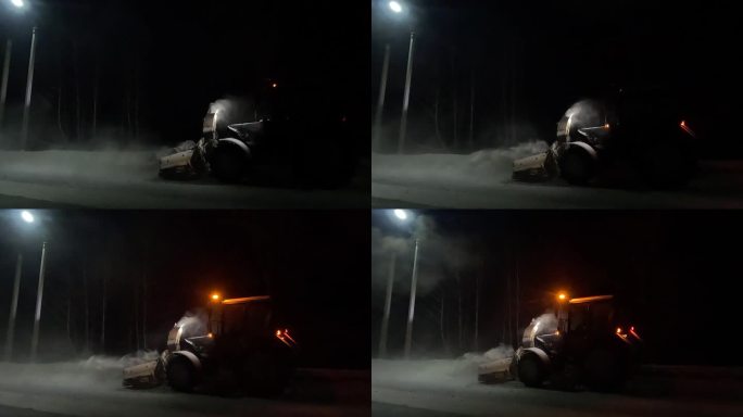 以拖拉机形式出现的除雪设备，在夜间作业，将道路上的雪扔进沟里