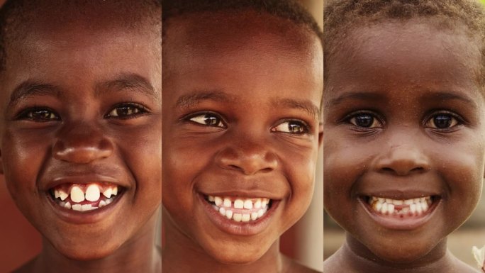 分屏拼贴:三个非洲儿童的垂直特写肖像，笑着对着镜头，小脸上充满了快乐和生活。相机捕捉童年的美