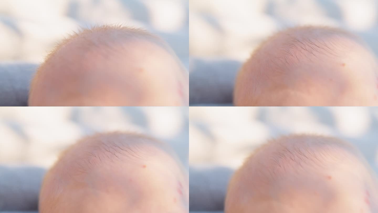 SLO - MO在阳光明媚的日子里截取了男婴头部的镜头