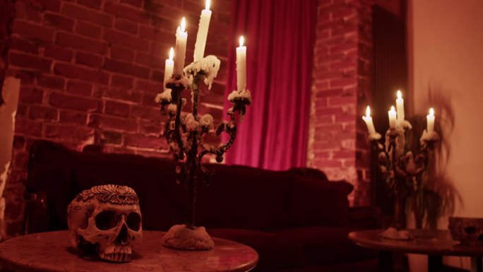 在家里的桌子上点着蜡烛，画着幽灵般的骷髅