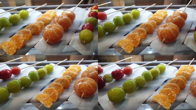 图为在韩国出售的塔古鲁糖浆糖衣水果橙色和亮麝香葡萄