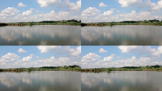 迷人的自然镜头一个湖在蓝天下与白色积云