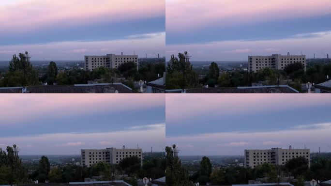 粉红灰蓝夕阳在工业城市。间隔拍摄。变焦