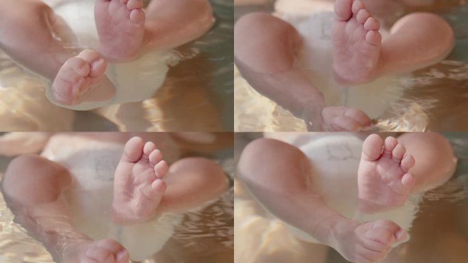 明亮之家浴缸里浮在水面上的小男孩的高角度低剖面拍摄