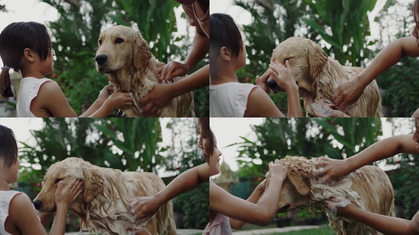 妈妈和女儿在后院给狗狗洗澡。