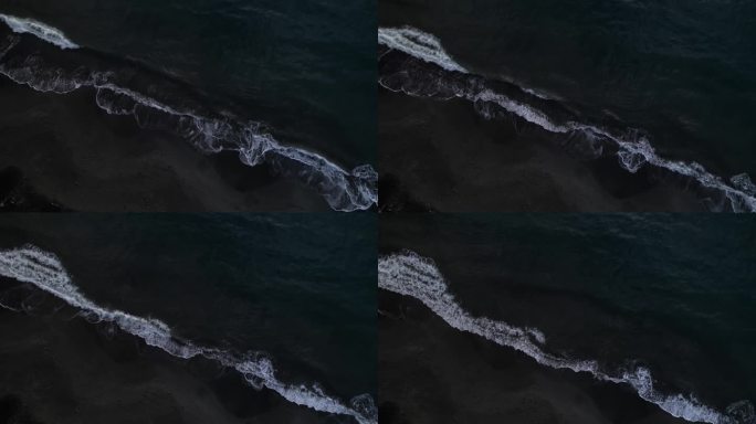 海浪冲击着黑沙滩，大安斯湾，瓜德罗普岛，法属安的列斯群岛。空中自上而下的向前和复制空间