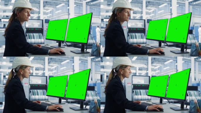 电子工厂办公室里，戴安全帽的白人女技术员在带有绿屏Chromakey模型显示器的台式电脑上工作。自主