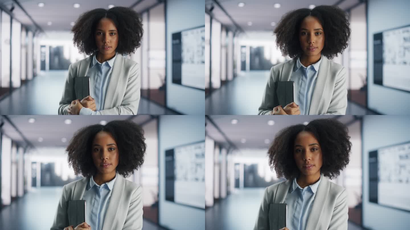 美丽的非洲裔美国大学生或办公室专家站在工作场所，拿着平板电脑。年轻有创意的黑人女性看着镜头。教育与商