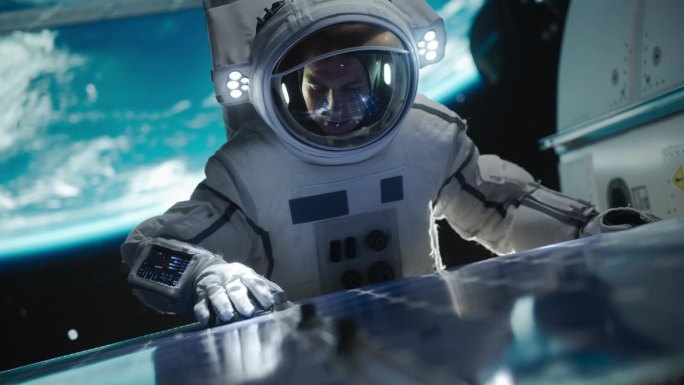 宇航员在远离地球的外太空执行舱外任务。在一次服务过程中，勇敢的人在空间站外固定和调整太阳能电池板模块