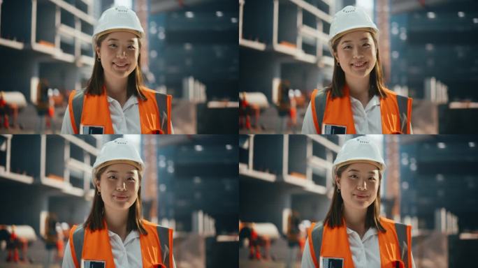 穿着安全制服和安全帽在住宅建筑工地的快乐亚洲土木工程师。站在户外微笑的专业日本女性工业现场经理
