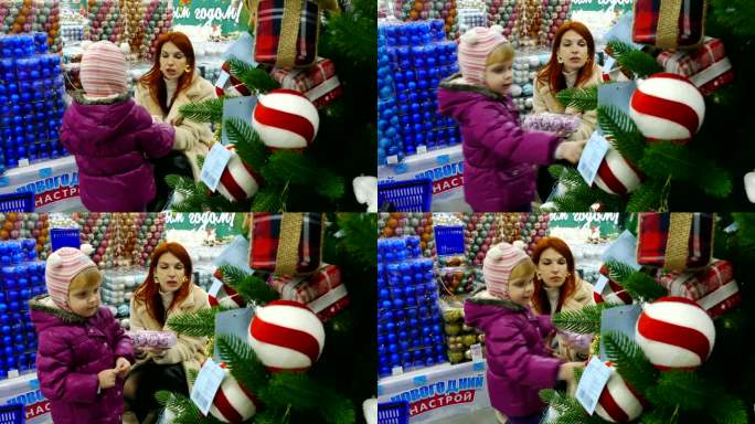 年轻女子和小女孩在圣诞市场