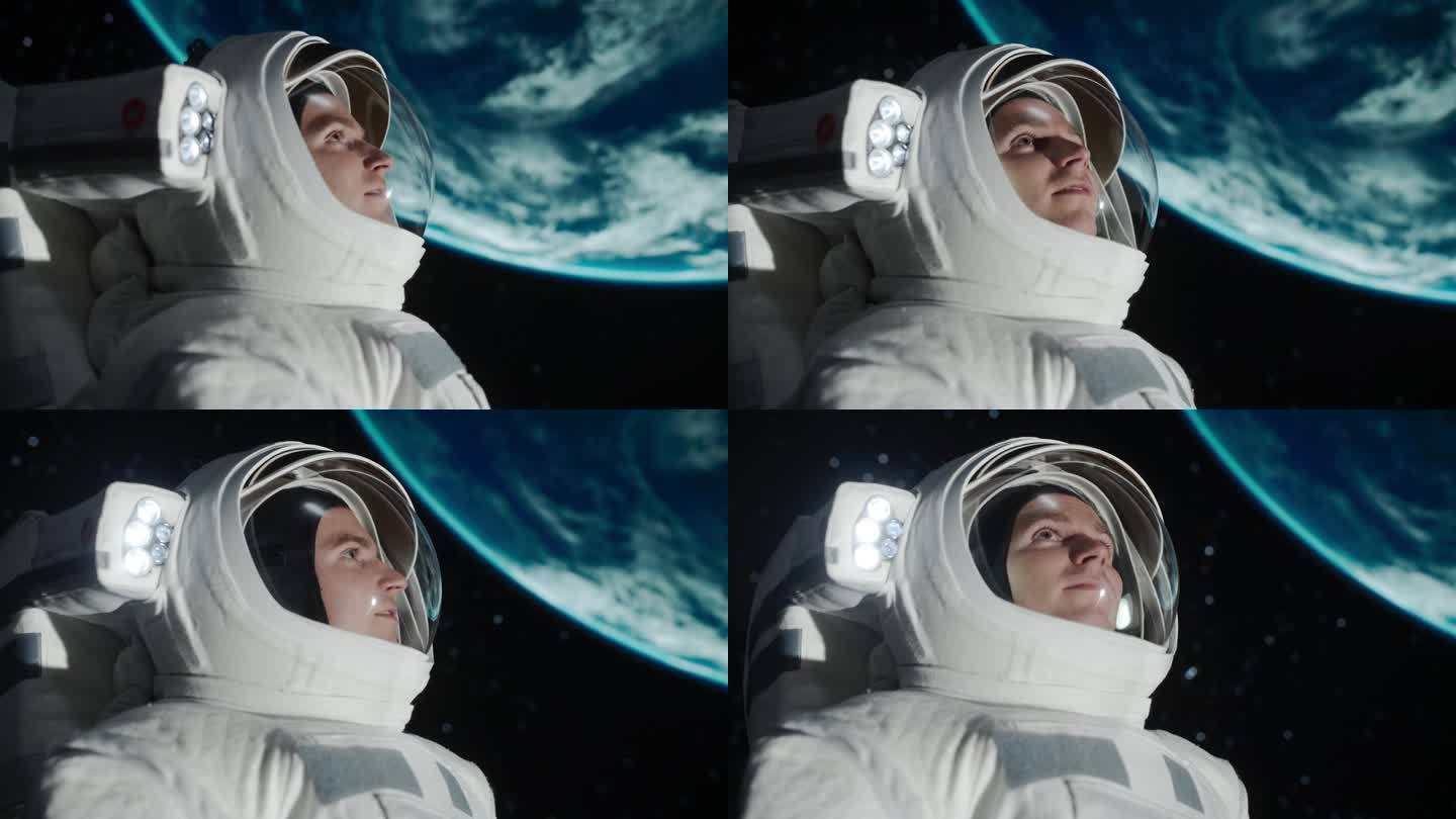 年轻的男宇航员第一次执行太空任务。一个英俊的宇航员漂浮在太空中，看着地球的特写。蓝色星球映在他的头盔