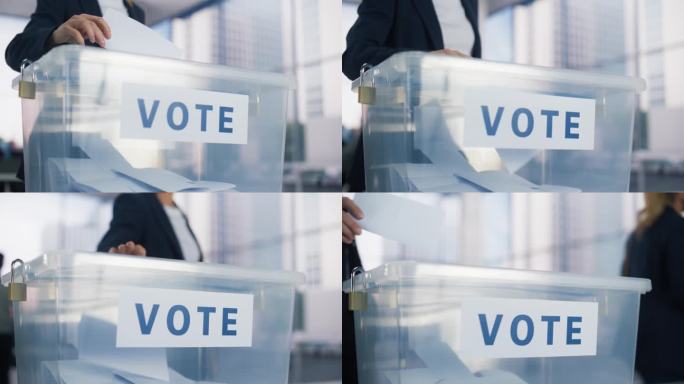 一名匿名男女选民投票并将选票放入密封箱的手特写。在选举日以一般无标志的方式到访投票站的市民