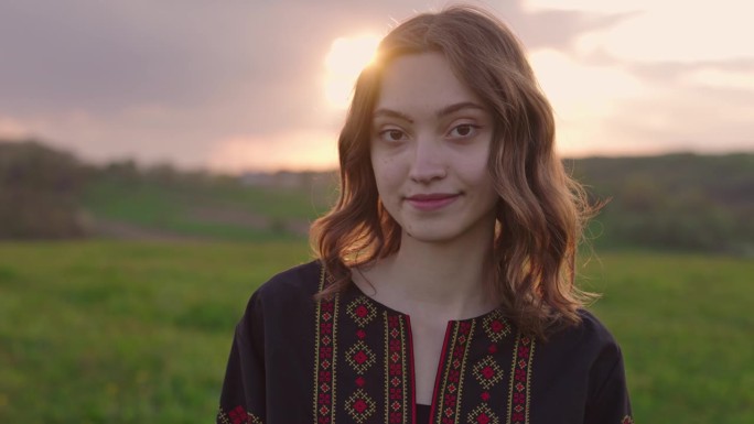 4k拍摄的年轻美丽的乌克兰妇女在vyshyvanka -乌克兰民族服装在日落期间在农村户外