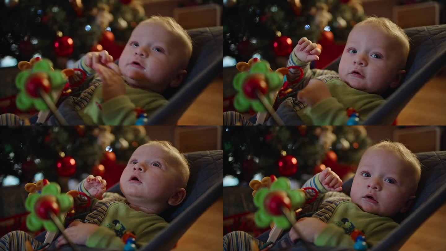 可爱的小男孩在家里的圣诞期间在保镖上摇摆的照片