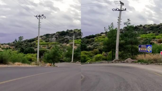 风景优美的乡村公路上行驶，蓝天之上。自驾游穿过乡村风景，柏油路在大自然。乡村公路探险，开车穿过群山，