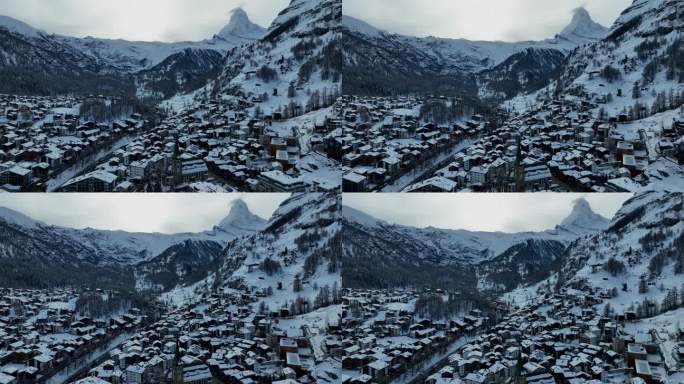 采尔马特滑雪胜地和小镇，背后是马特洪峰和房屋，这是瑞士阿尔卑斯山脉多云的冬日。航拍无人机视频