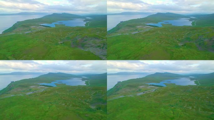 航拍:绿色的高原上有许多徒步旅行的小径，点缀着两个蓝色的湖泊