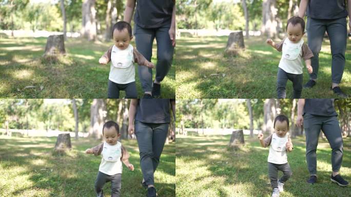 在户外公园里，小男孩向妈妈迈出了第一步