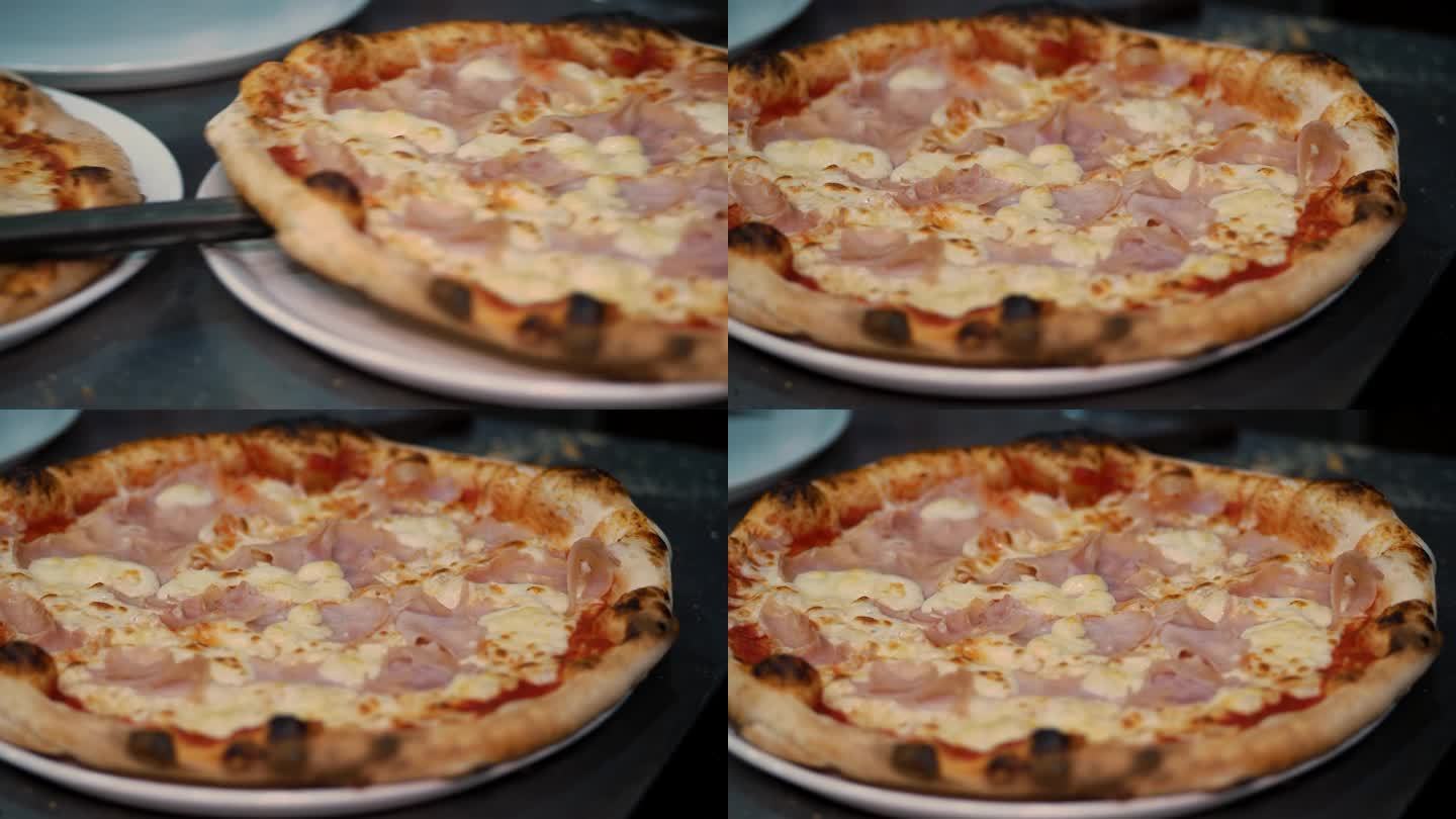 刚从石炉里出炉的披萨。在他的餐厅里，厨师用盘子为顾客端上意大利披萨。