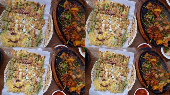 当地的韩国食物，蔬菜煎饼和猪辣酱配菜，俯视慢动作4k