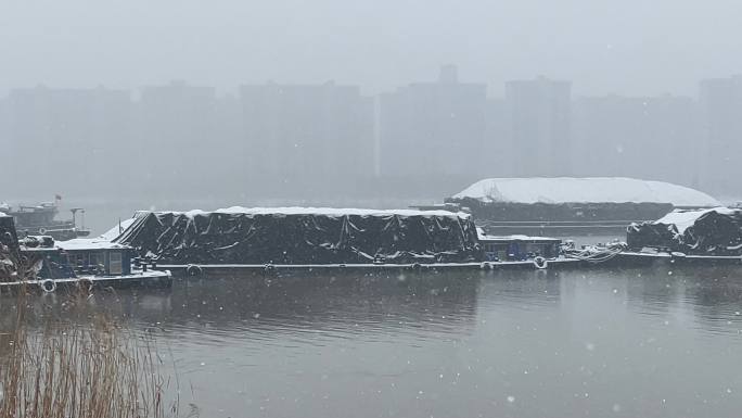 大雪中京杭大运河上的运输船只