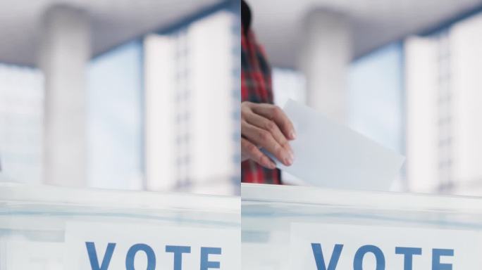 竖屏:现代投票站，成年白人男子将选票投进密封箱。美国人民在美国选举日行使公民义务