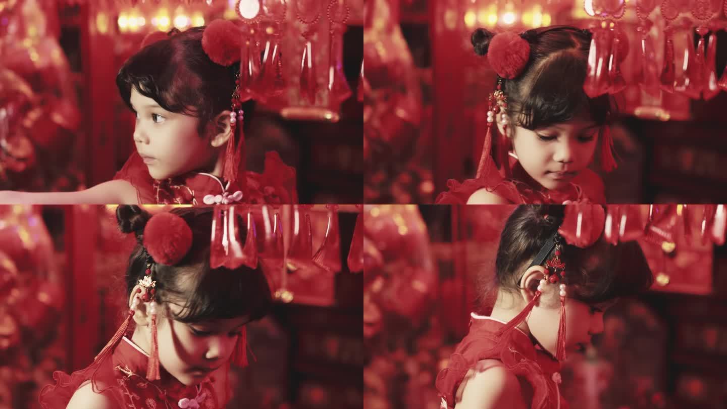 可爱的小女孩穿着中国服装看红灯笼