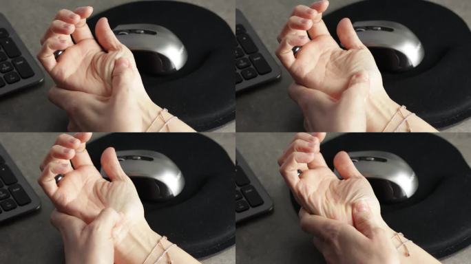 一个女人因使用电脑而手部疼痛的特写。