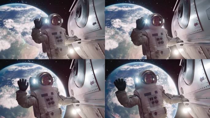 一名宇航员漂浮在宇宙飞船外的肖像，背景是地球。男:对着镜头挥手。职业太空人穿着太空服，微笑着摆姿势