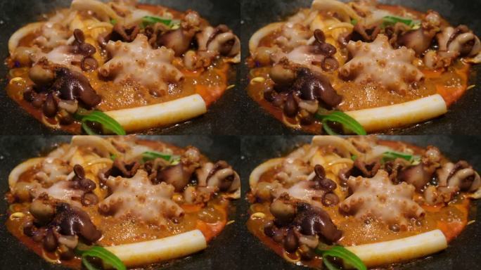 烹饪韩式铁板辣炒八爪鱼的慢动作特写