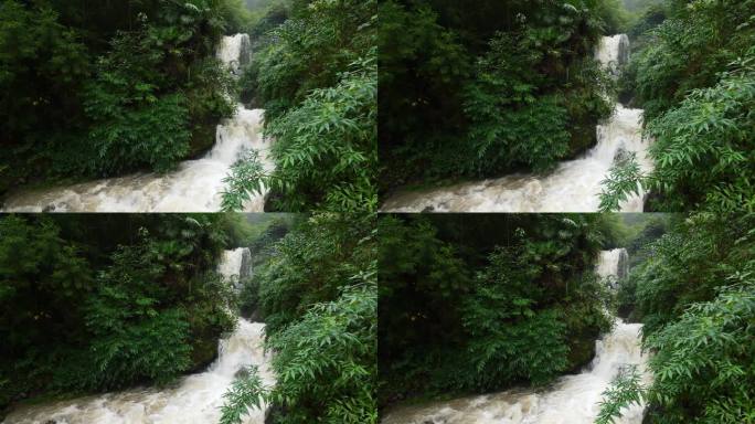 雨季的瀑布。峡谷之间湍急的瀑布河。大雨过后，泥土正在往下移。巨大翻滚的棕色浑水。4k慢动作镜头b滚拍