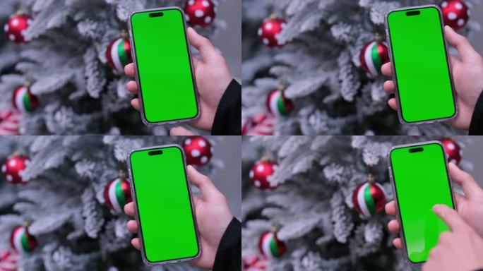 圣诞节，手点击滑动使用绿色屏幕的智能手机