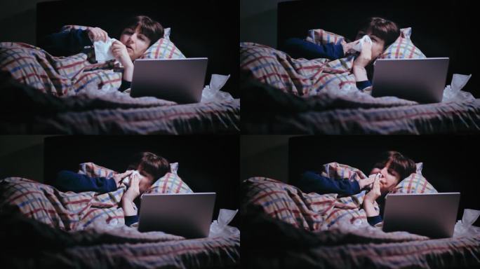 治愈之夜:女人独自躺在沙发上，咳嗽，在笔记本电脑旁用纸巾擤鼻涕