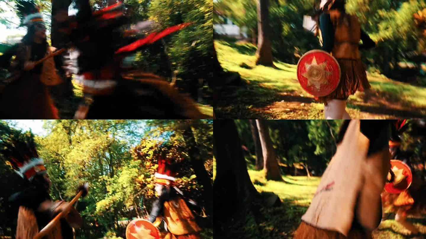 一对妇女身穿传统服装，手持长矛和盾牌在森林中厮杀
