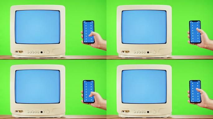 绿色背景干扰屏的旧电视和蓝色色度键的智能手机。复古电视特写，怀旧。灰色噪音屏幕和故障。