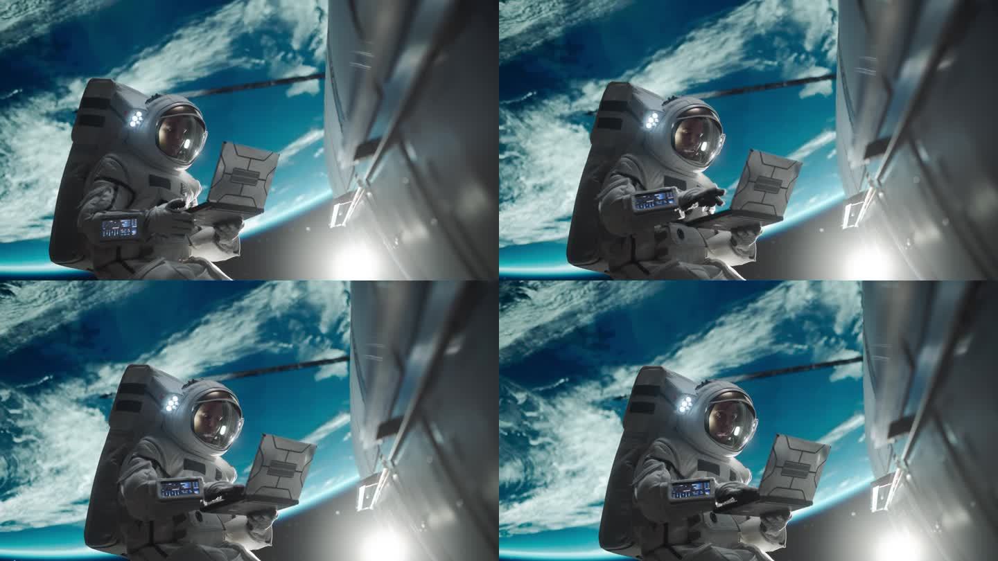 男宇航员用笔记本电脑无线连接卫星。宇航员在地球大气层外的开放空间中工作。从事维修保养工作的专业工程师