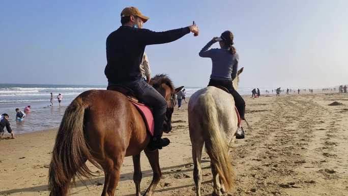 海边沙滩骑马行走沙滩赶海大海海边行马游玩