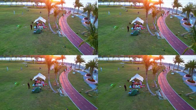 海南三亚春季阳光、草坪上的露营放风筝