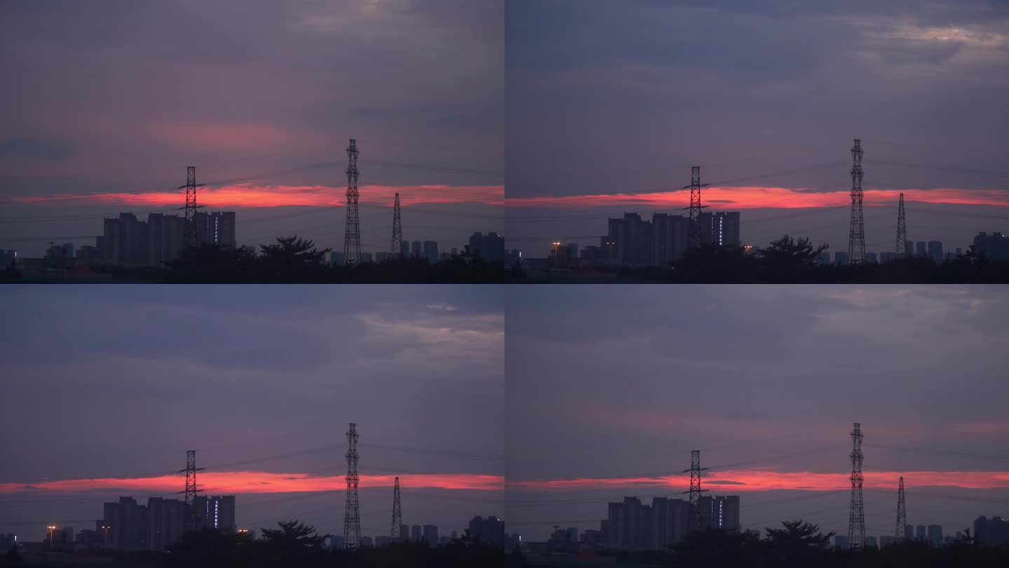 黄昏时刻红色的云飘过输电塔
