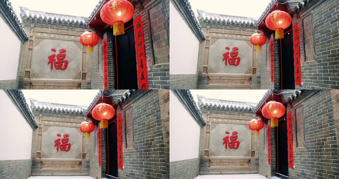 新年春节中式庭院雪中贴对联贴福字红灯笼