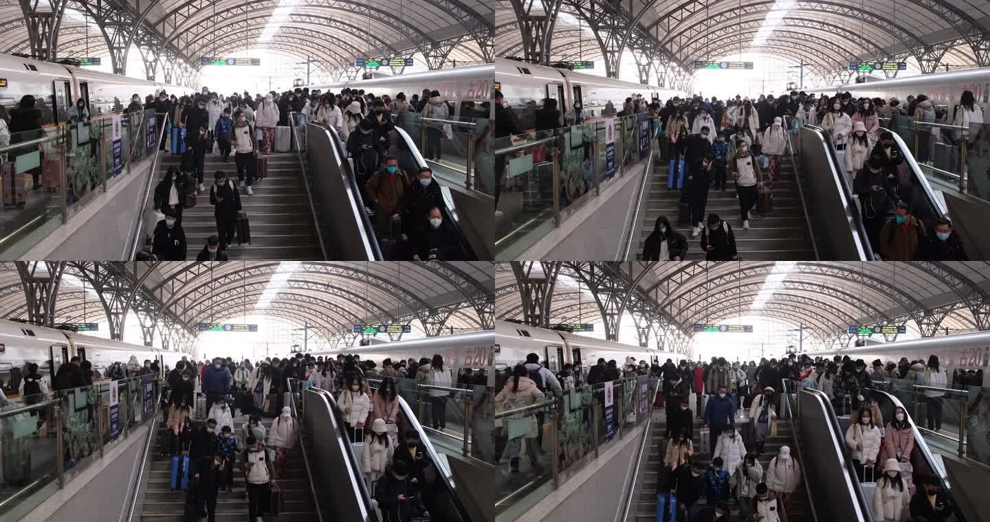 很多旅客从火车站站台下楼梯出站，春运人潮
