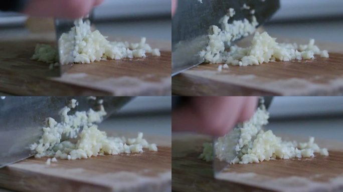 菜刀在砧板上切大蒜的超慢动作特写