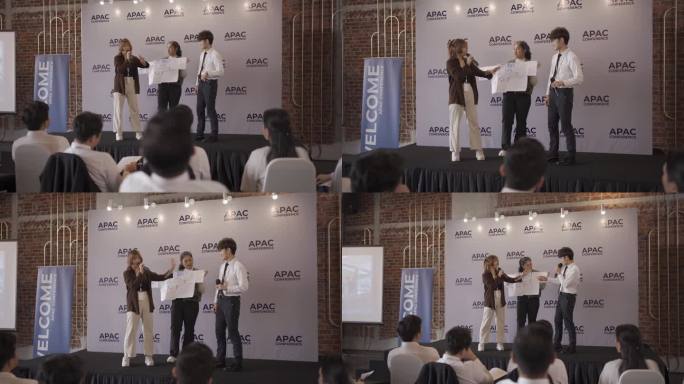 工作坊亚洲华人年轻女子在舞台上解释她的想法和概念，与研讨会的参与者分享
