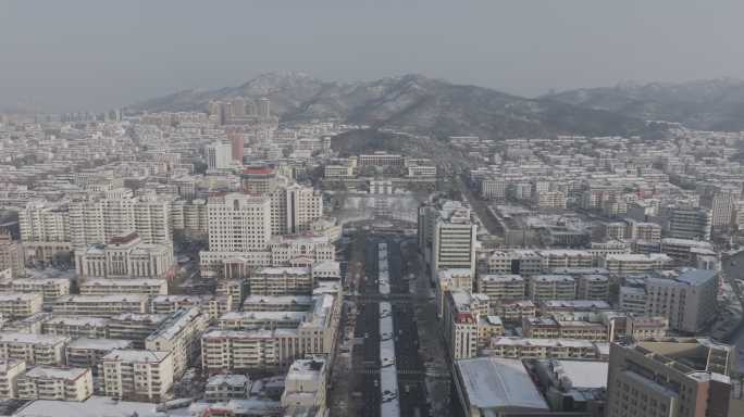 航拍威海市人民广场政府大楼冬季雪景