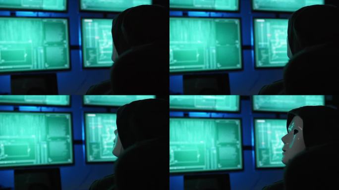 一名黑客程序员穿着连帽衫，戴着黑色黑客面具隐藏自己的身份，利用电脑进行黑客攻击，这是黑暗互联网的概念