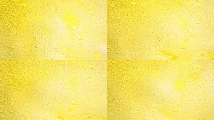 以1000帧/秒的速度拍摄冒泡的黄色柠檬水抽象背景。