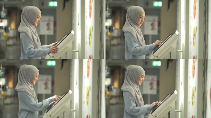 4K年轻穆斯林妇女使用Kiosk触摸屏显示