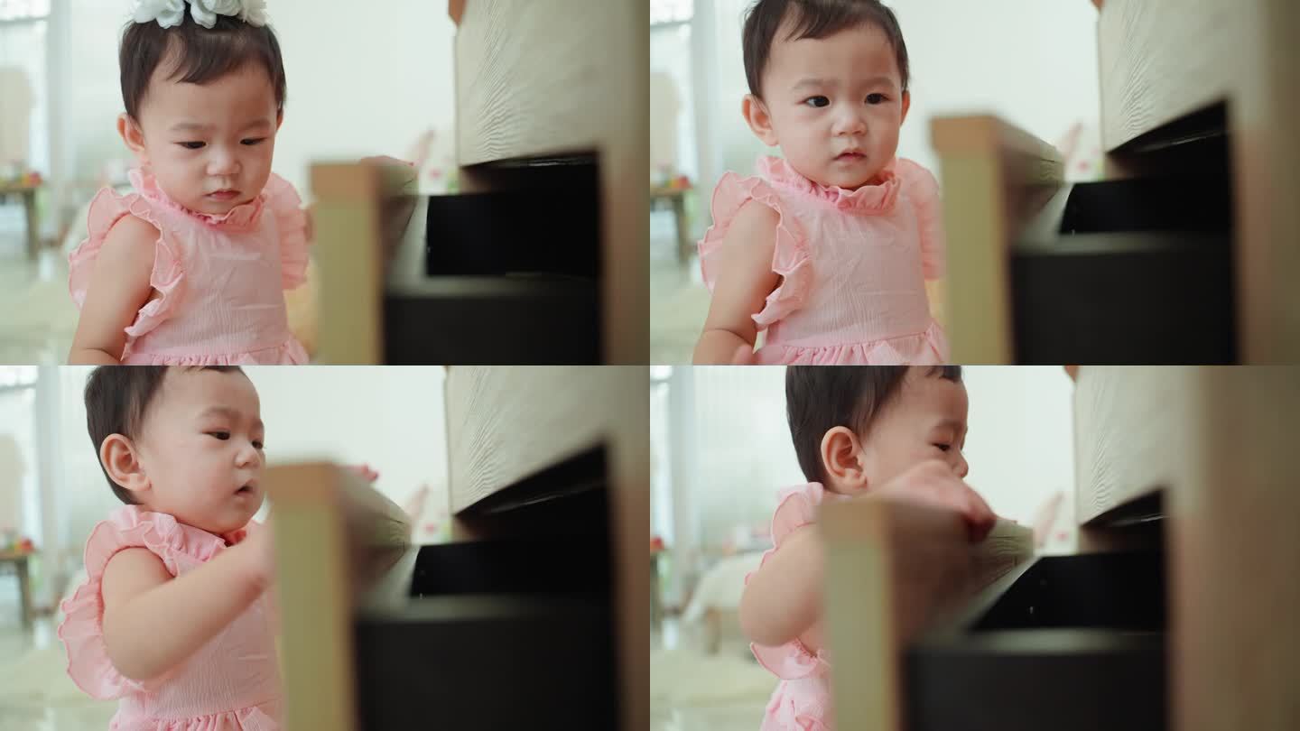 一个穿着粉色裙子的亚洲小女孩站在一个敞开的抽屉柜前，在里面找东西，因为找不到她的玩具而哭了。儿童学习